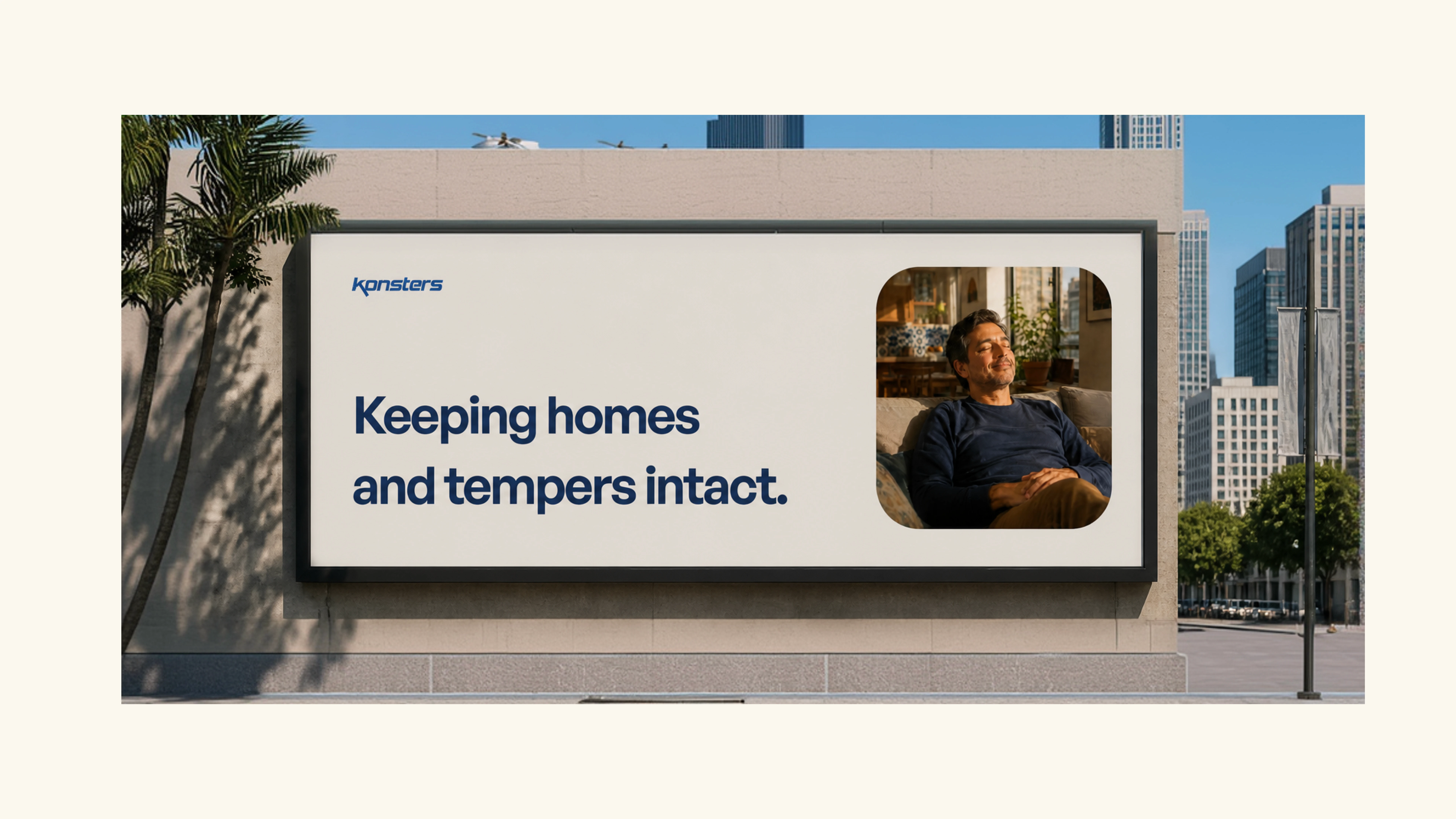 A large outdoor billboard on a city street featuring the Konsters logo, the headline “Keeping homes and tempers intact,” and a photo of a relaxed man sitting at home. Palm trees and modern buildings surround the billboard.
