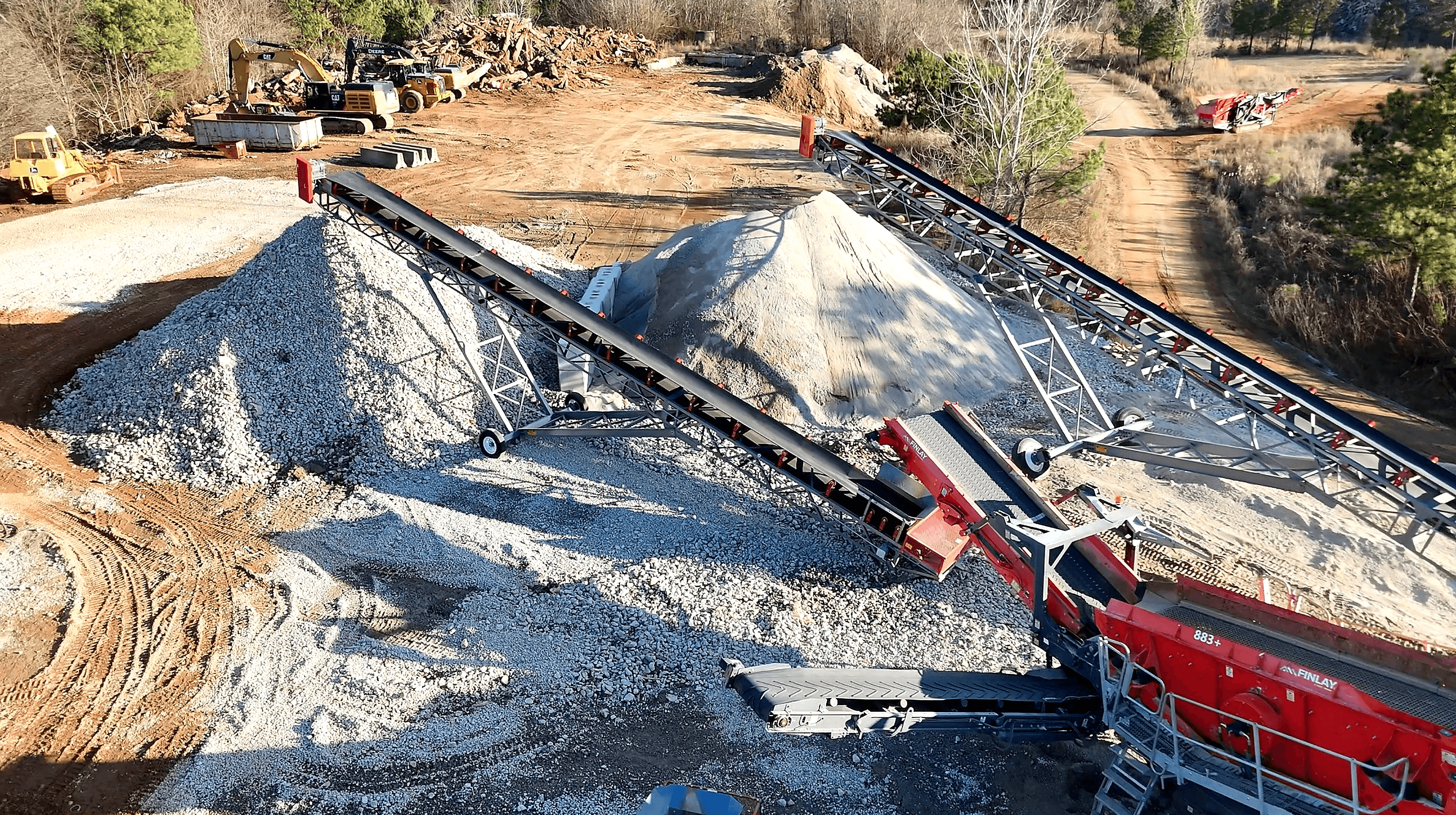 man in gray hoodie and blue denim jeans standing on brown wooden parquet flooring