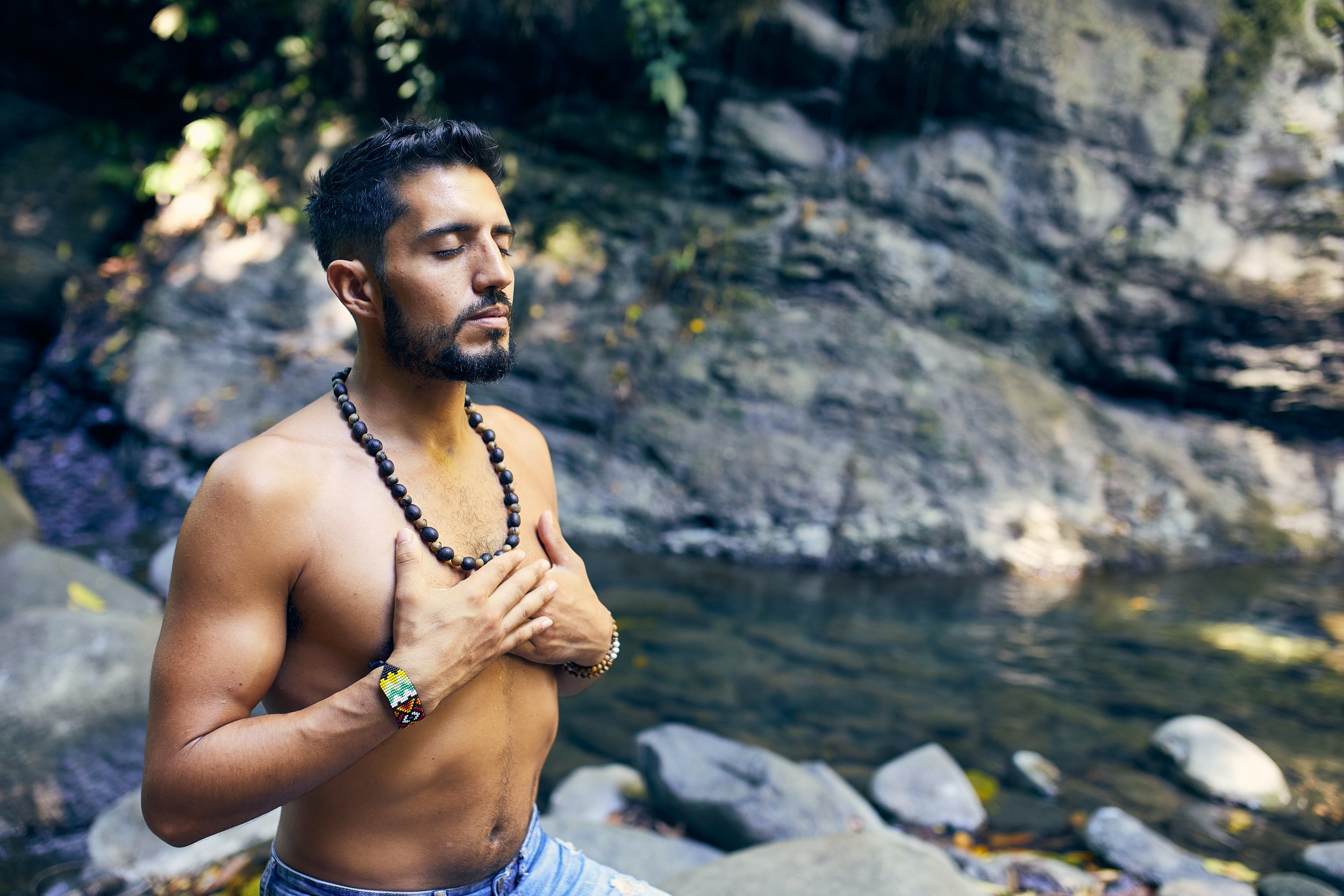 Serene man deeply immersed in meditation, showcasing the tranquil and transformative experience offered at wellness retreats.