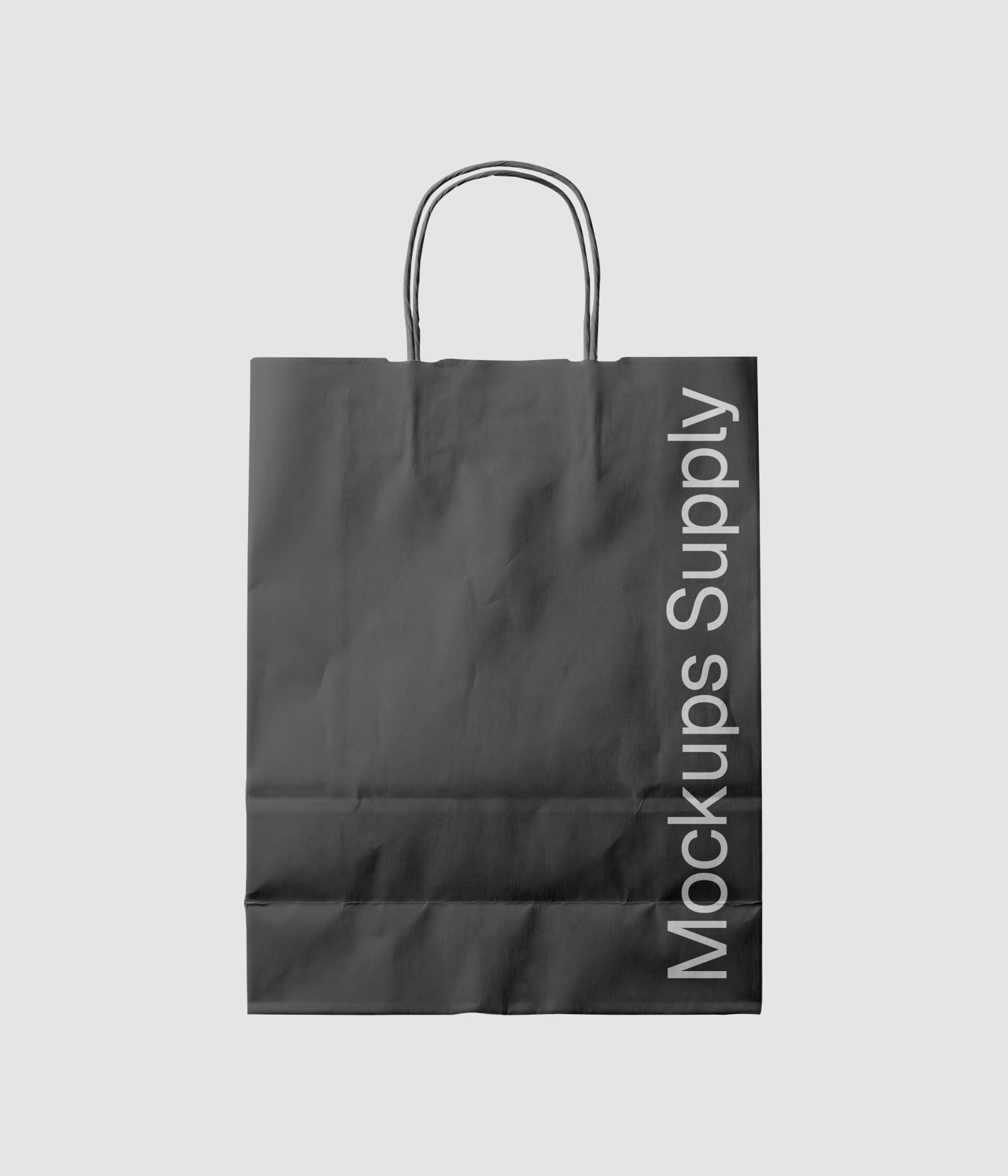 Textured crumpled paper shopping bag mockup with twisted handle styled in soft, directional lighting download PSD