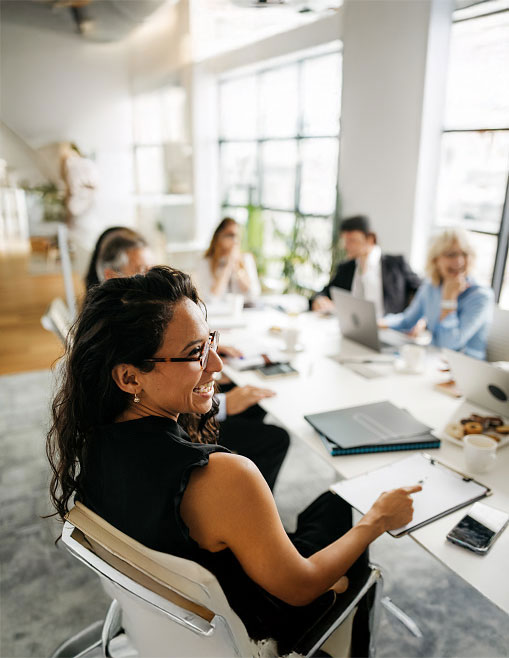 Image of a team, in a modern office, smiling and having a good time