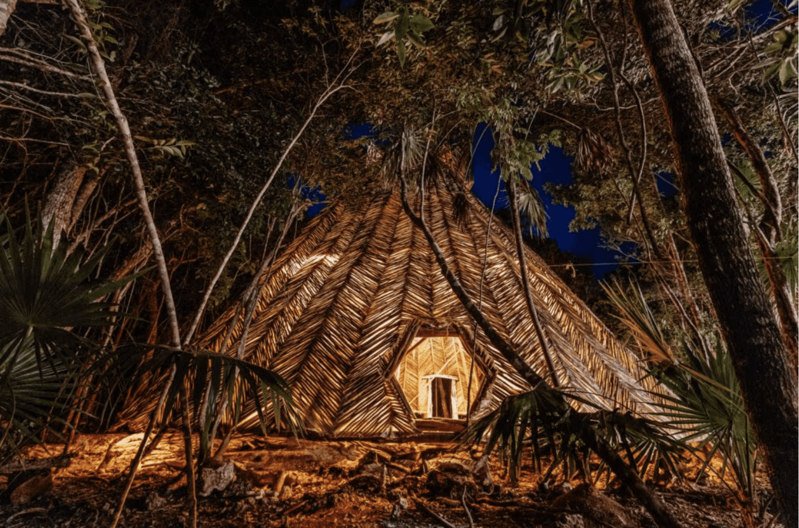 A group of smiling people, dressed in casual light-colored clothing, walks joyfully through a charming cobblestone street lined with market stalls, each person carrying baskets overflowing with fresh produce, bread, and flowers.