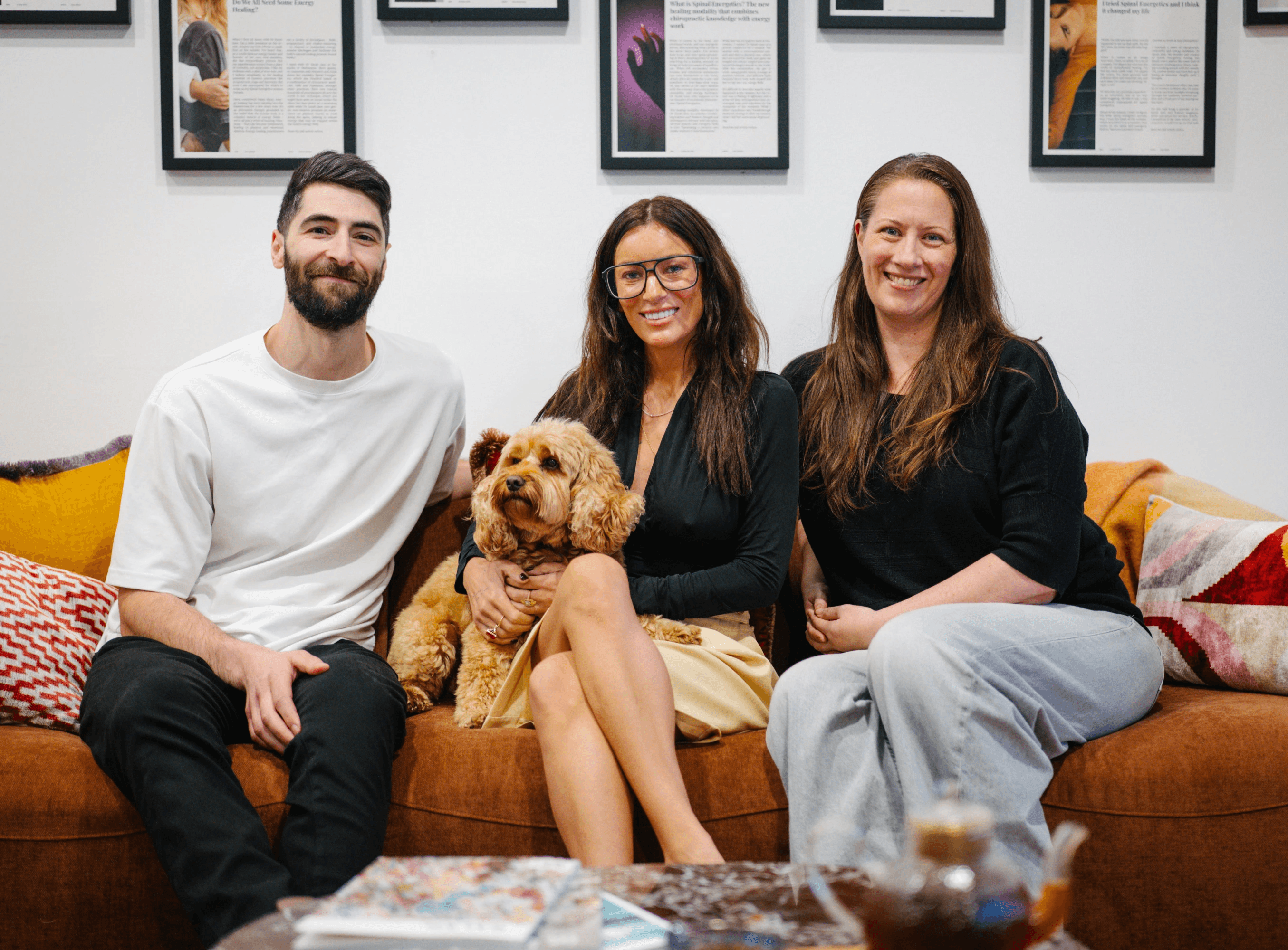 Spinal Energetics Teaching Team_Pat a male with short dark hair and beard, Cooper the cavoodle, Dr Sarah with long dark hair, navy long sleeve top and yellow skirt, Heidi with long brown hair, black top and light jeans