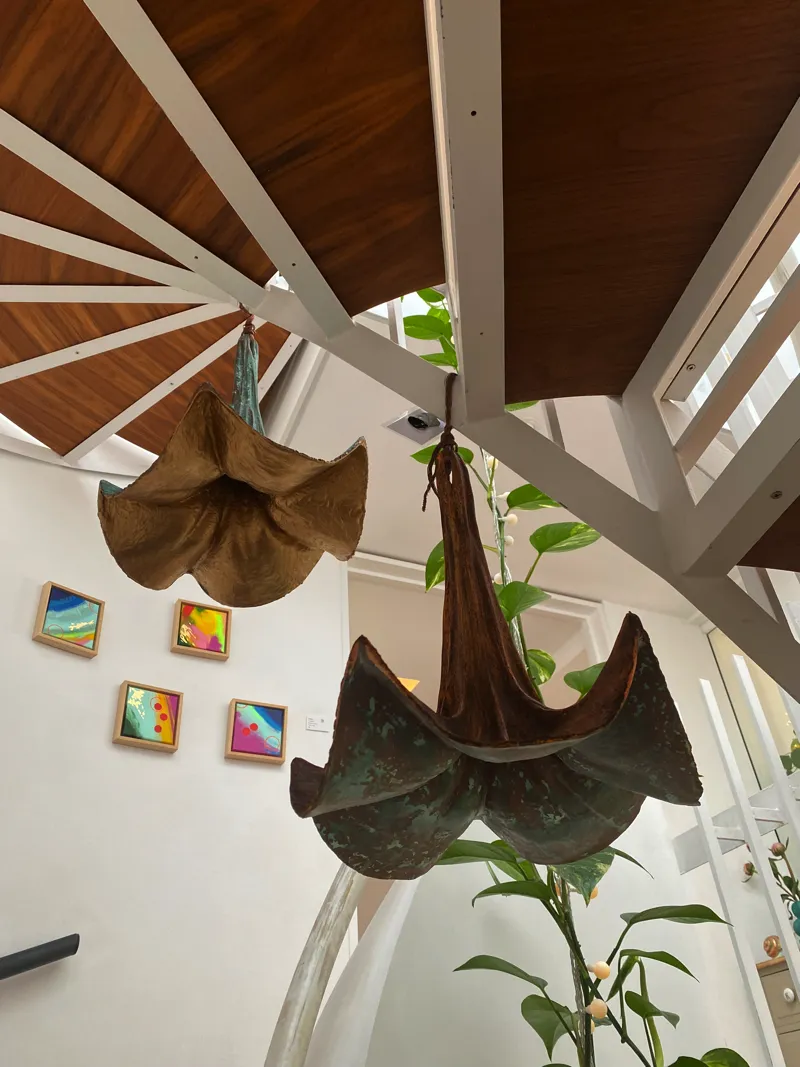 trumpet flowers hanging under stairs by Abby Martin