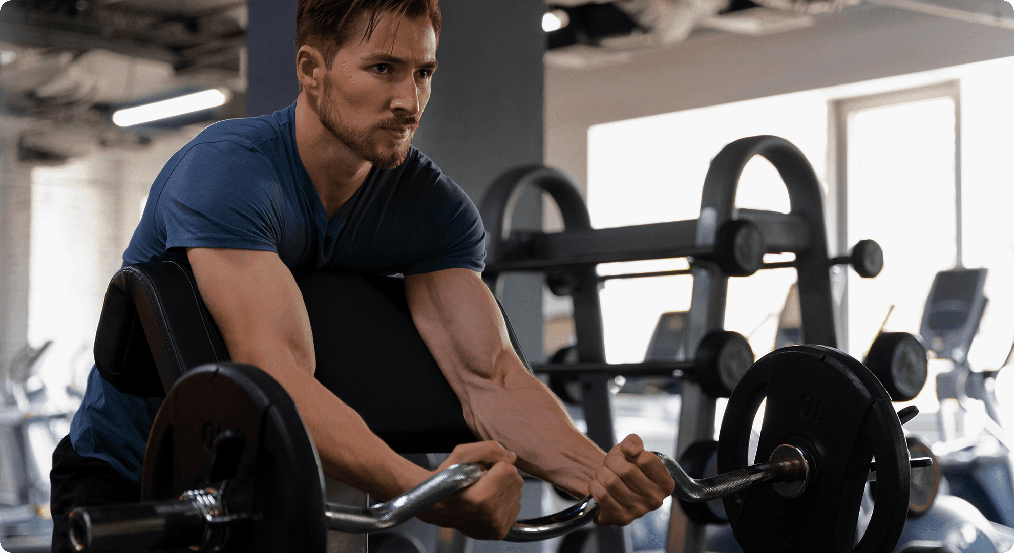 Young handsome man training at the gym for bodybuilding