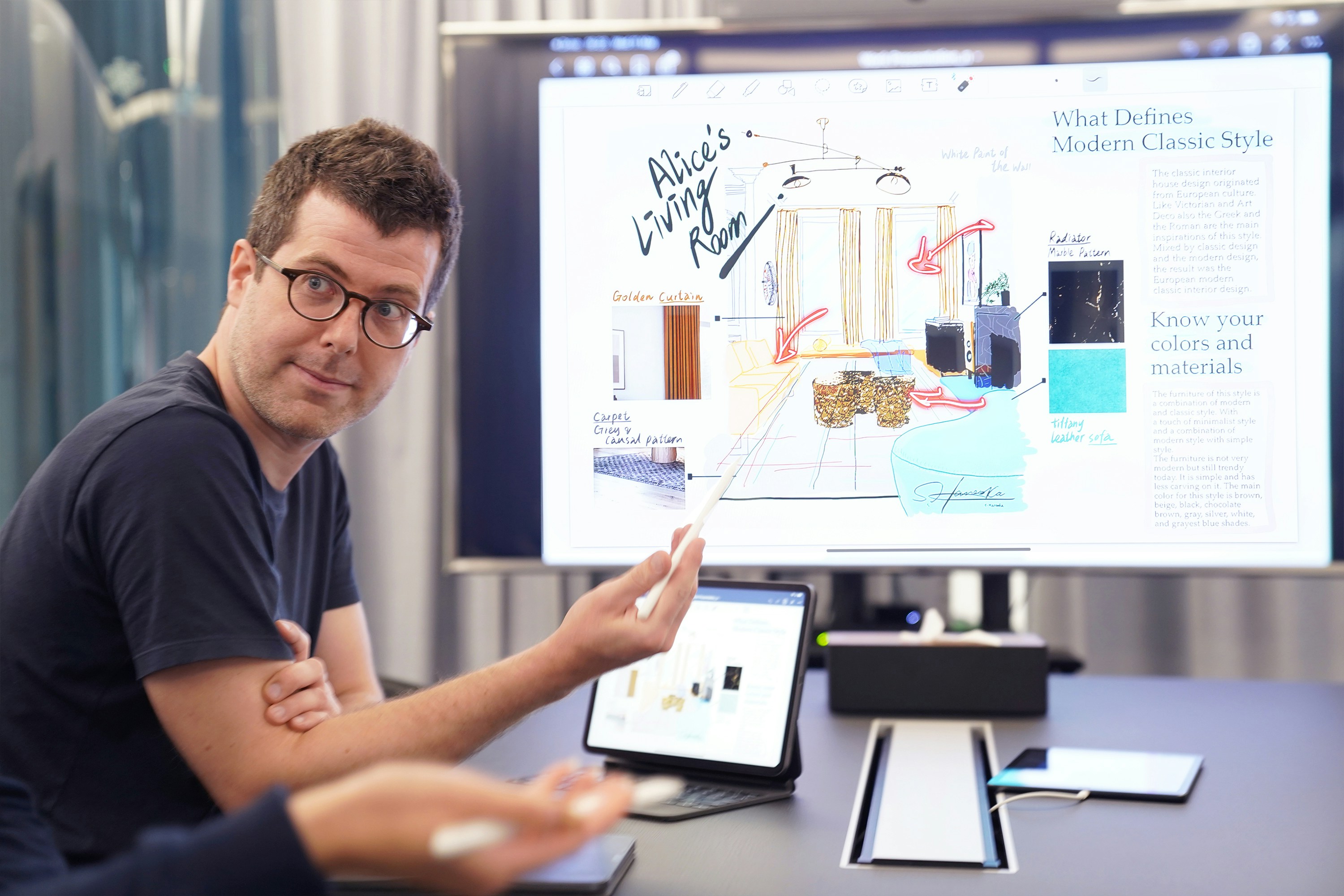 A man presenting in front of a computer.