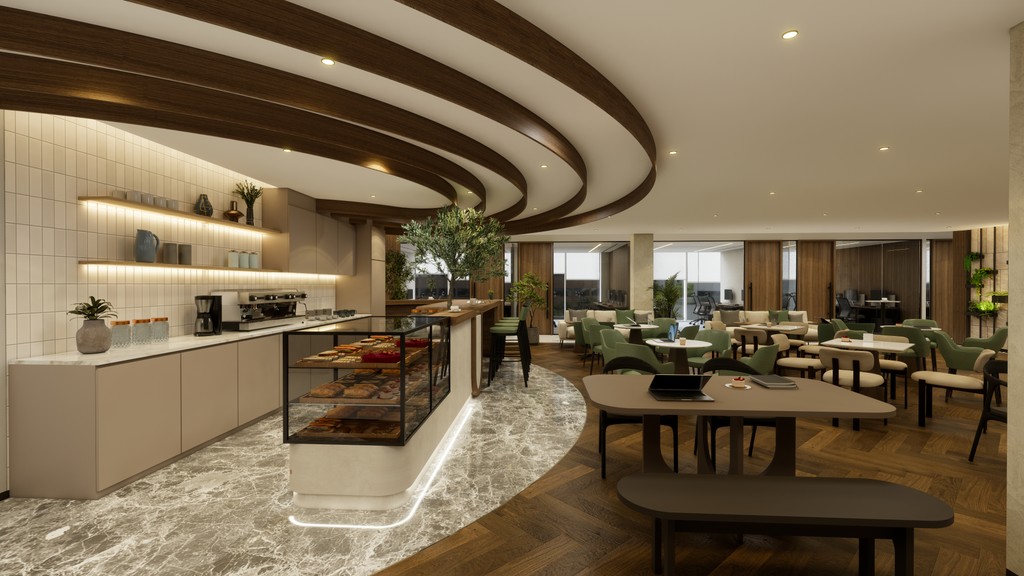 Café-style pantry and lounge area in serviced office spaces in Dubai with display counters, bar seating, and greenery.