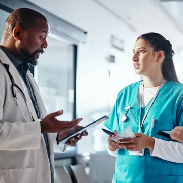 Nurse and doctor reviewing clinical standards