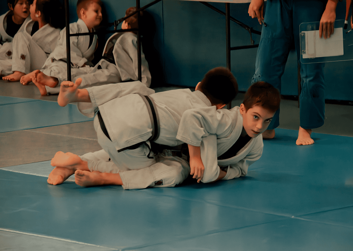 Kids performing groundwork techniques during a Jiu Jitsu class