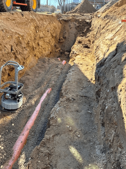 black and yellow heavy equipment on brown rock formation during daytime