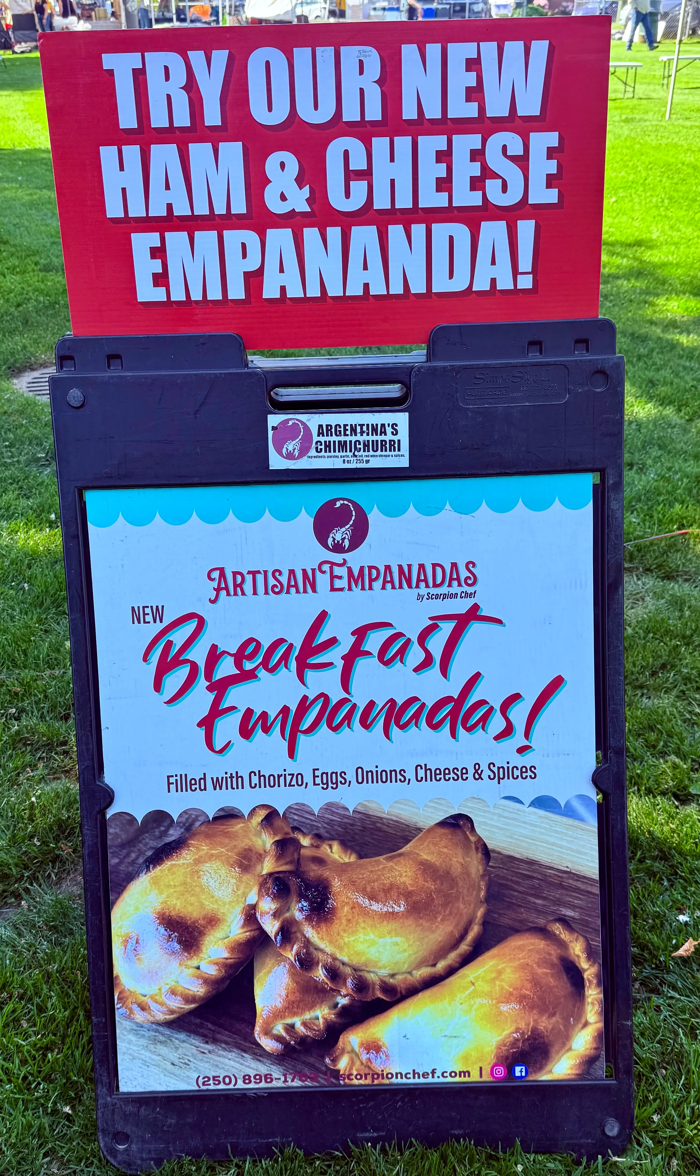 Scorpion Chef new ham and cheese and breakfast empanadas sandwich board sign at Vancouver Island farmer's market BC