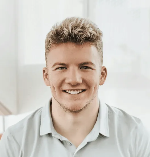 man in gray polo shirt smiling