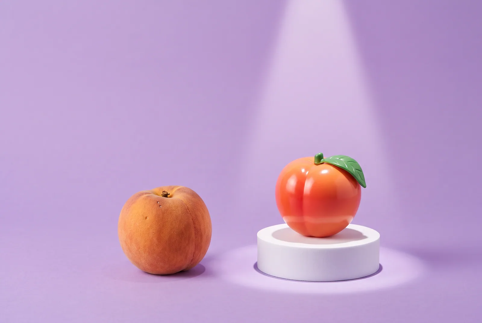 Real ripe peach next to a flawless plastic peach on a spotlit pedestal, showing why a boyfriend watching porn can make you insecure