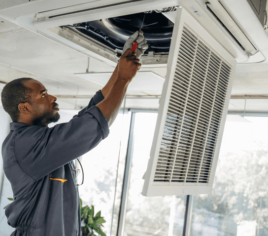 HVAC technician performing professional duct cleaning in a Toronto home to improve airflow, remove dust buildup, and enhance indoor air quality.