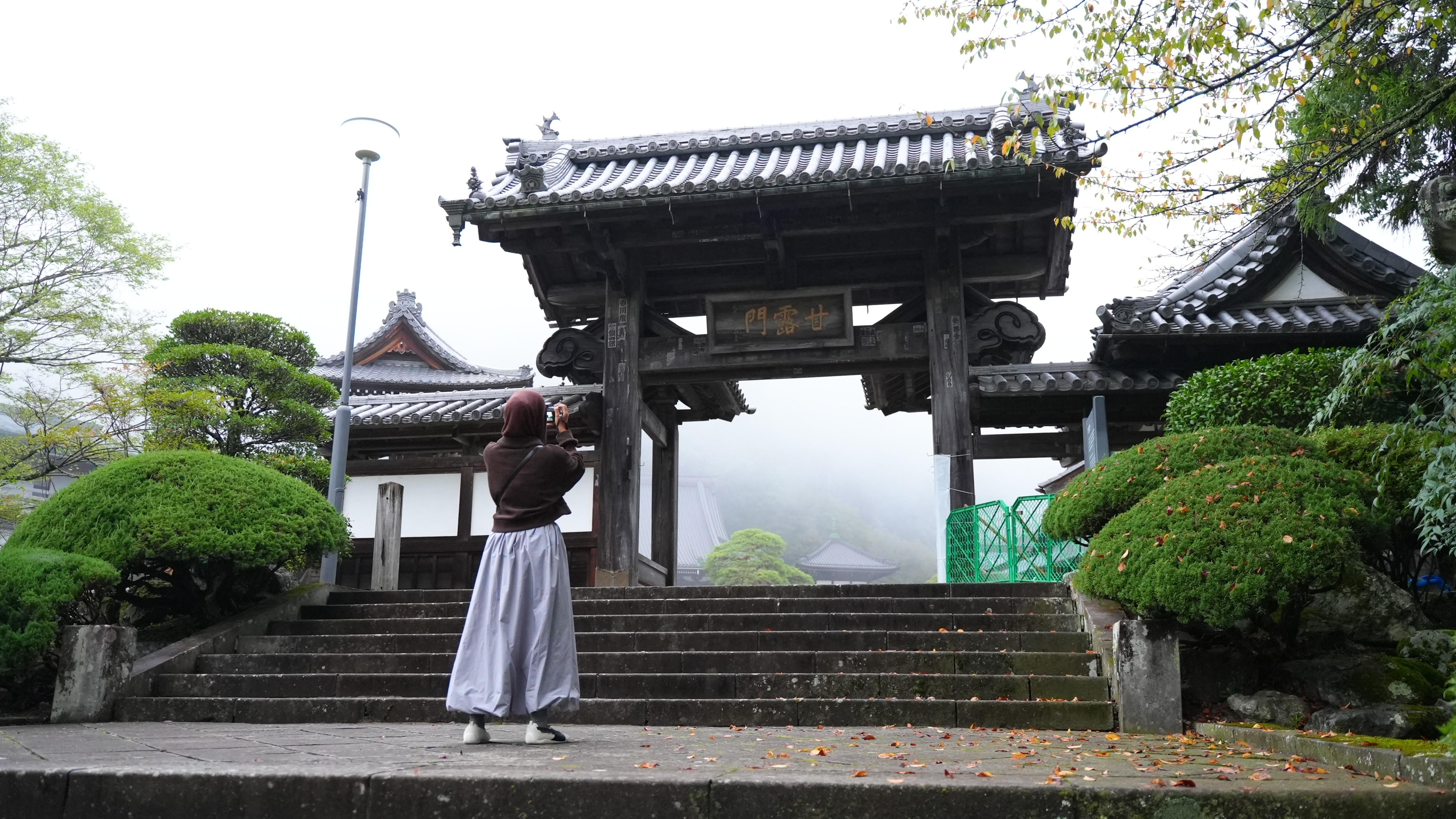 A woman standing in front of a building