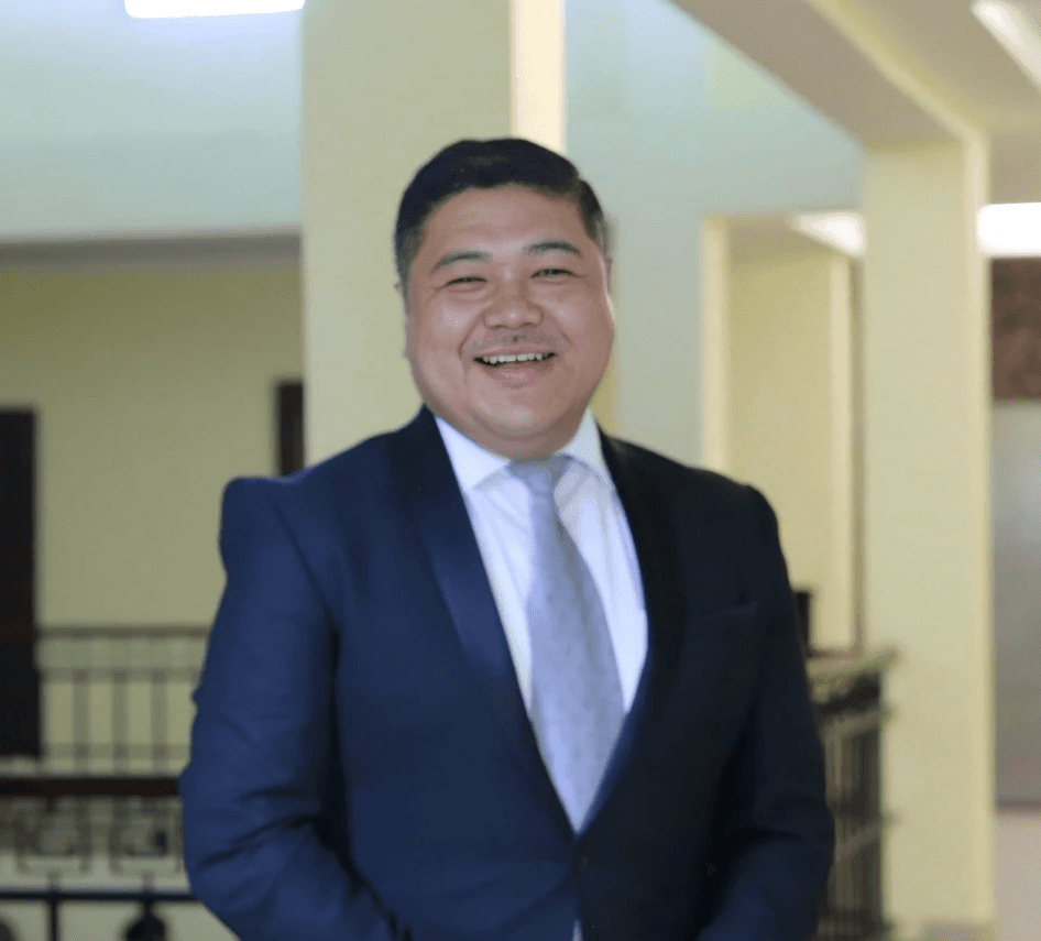 woman in black crew neck t-shirt wearing brown framed eyeglasses standing on rocky shore during