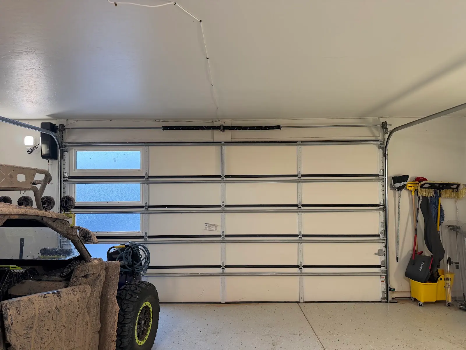 White insulated garage door w/ windows. Rio Rancho garage door repair & installation.