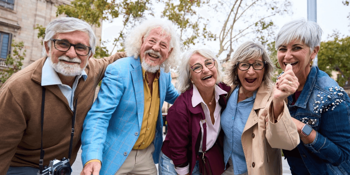 A group of senior individuals smiling and enjoying together, reflecting the growing demand for personalized boutique senior care.