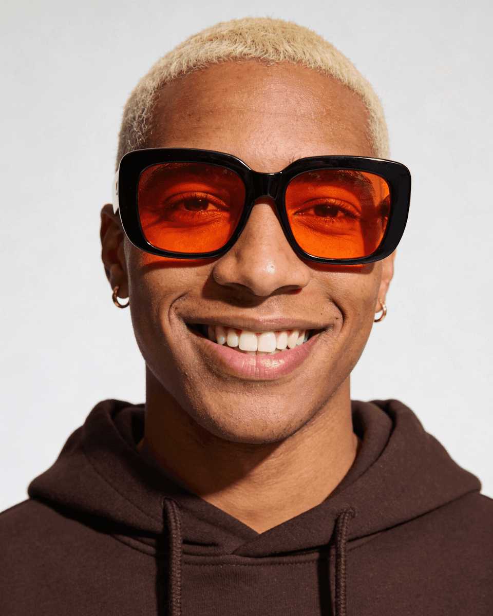 Full moon glowing behind dark clouds at night