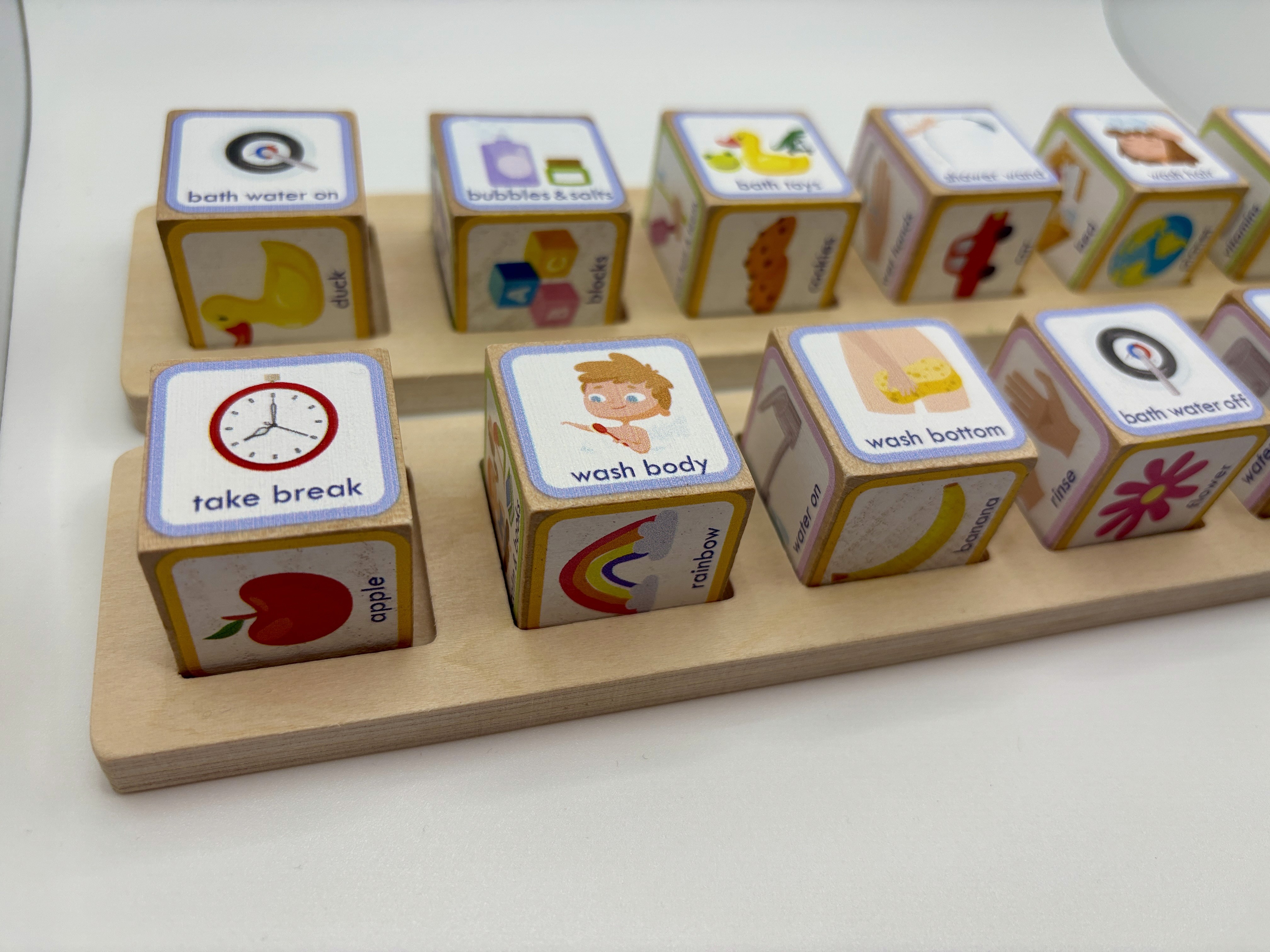 wooden blocks in a tray that show executive functioning steps for taking a bath