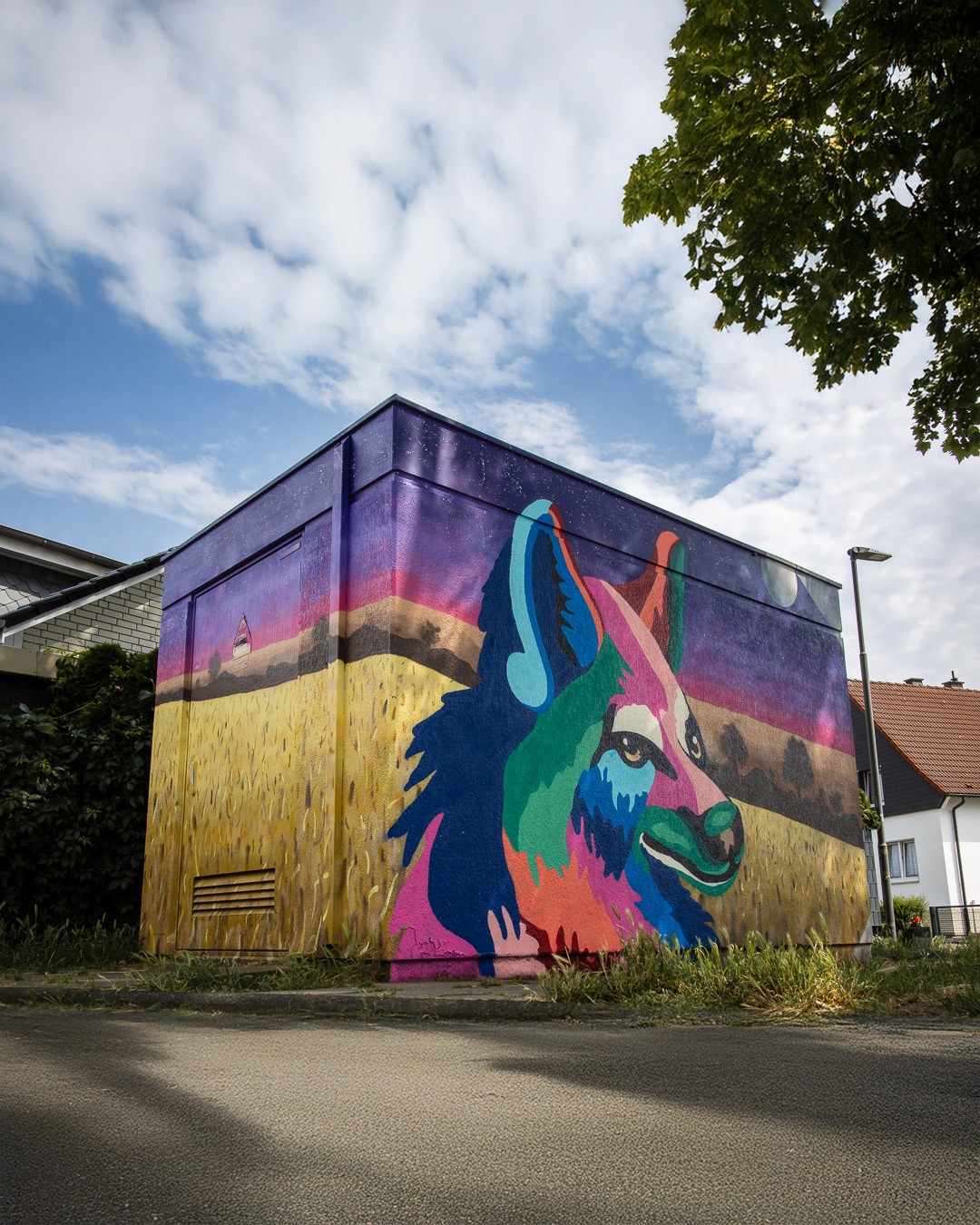 Colorful abstract fox in a field // Urban art graffiti on electrical box