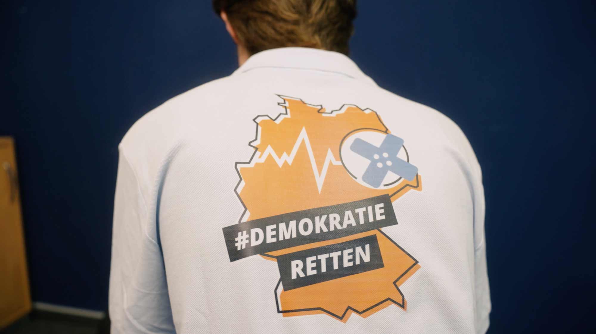 Back of a shirt featuring a map design with campaign hashtag, symbolizing strategic storytelling in film and social media campaigns.