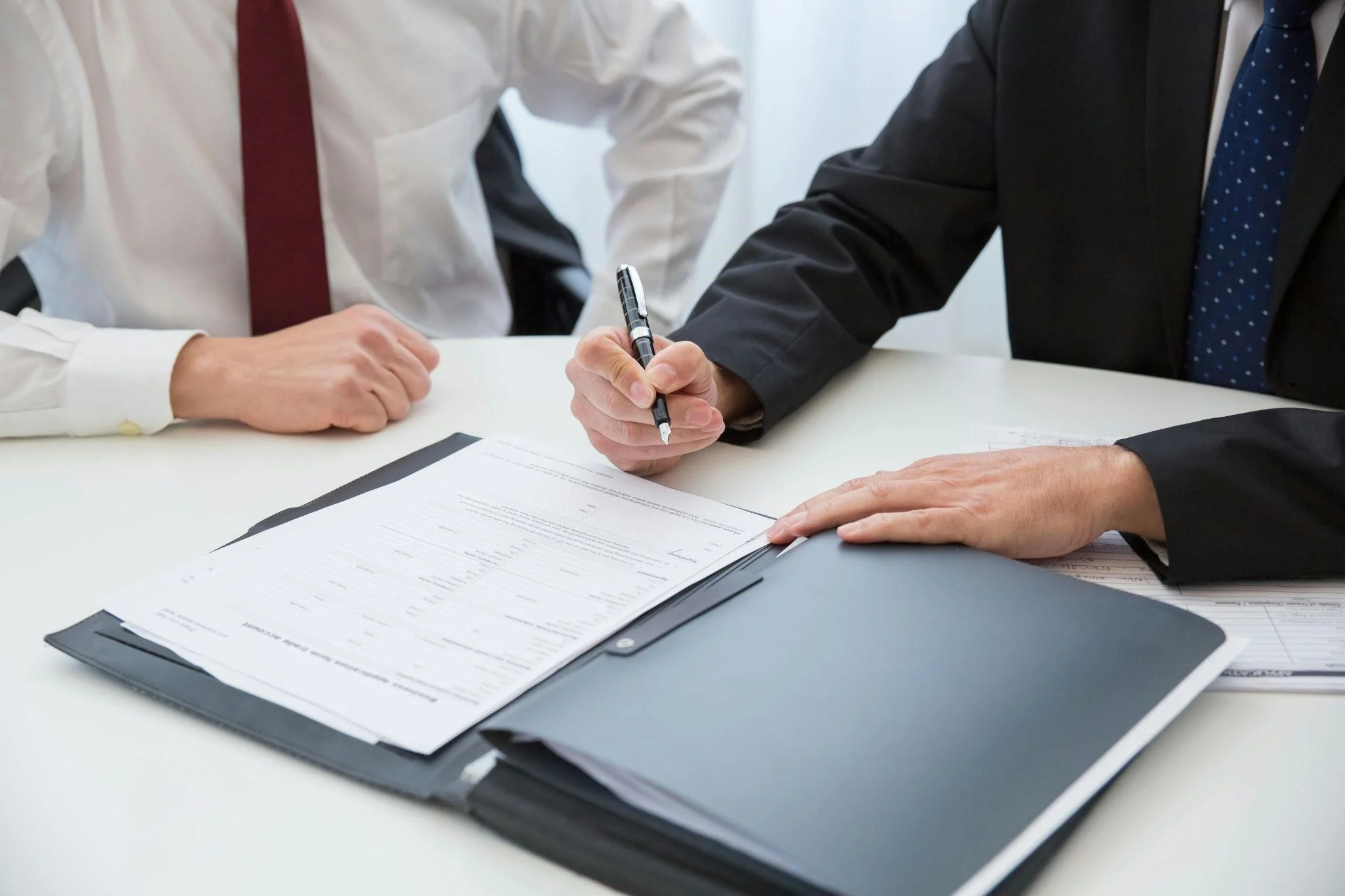 A property manager signing a commercial snow removal contract.