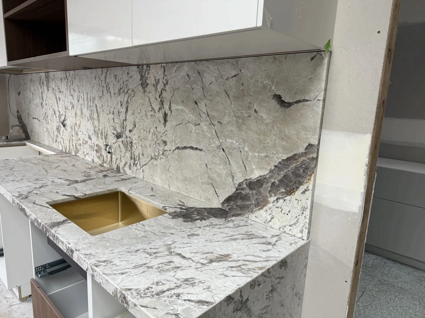 Natural stone marble splashback slab prepared for kitchen installation with grey veining.