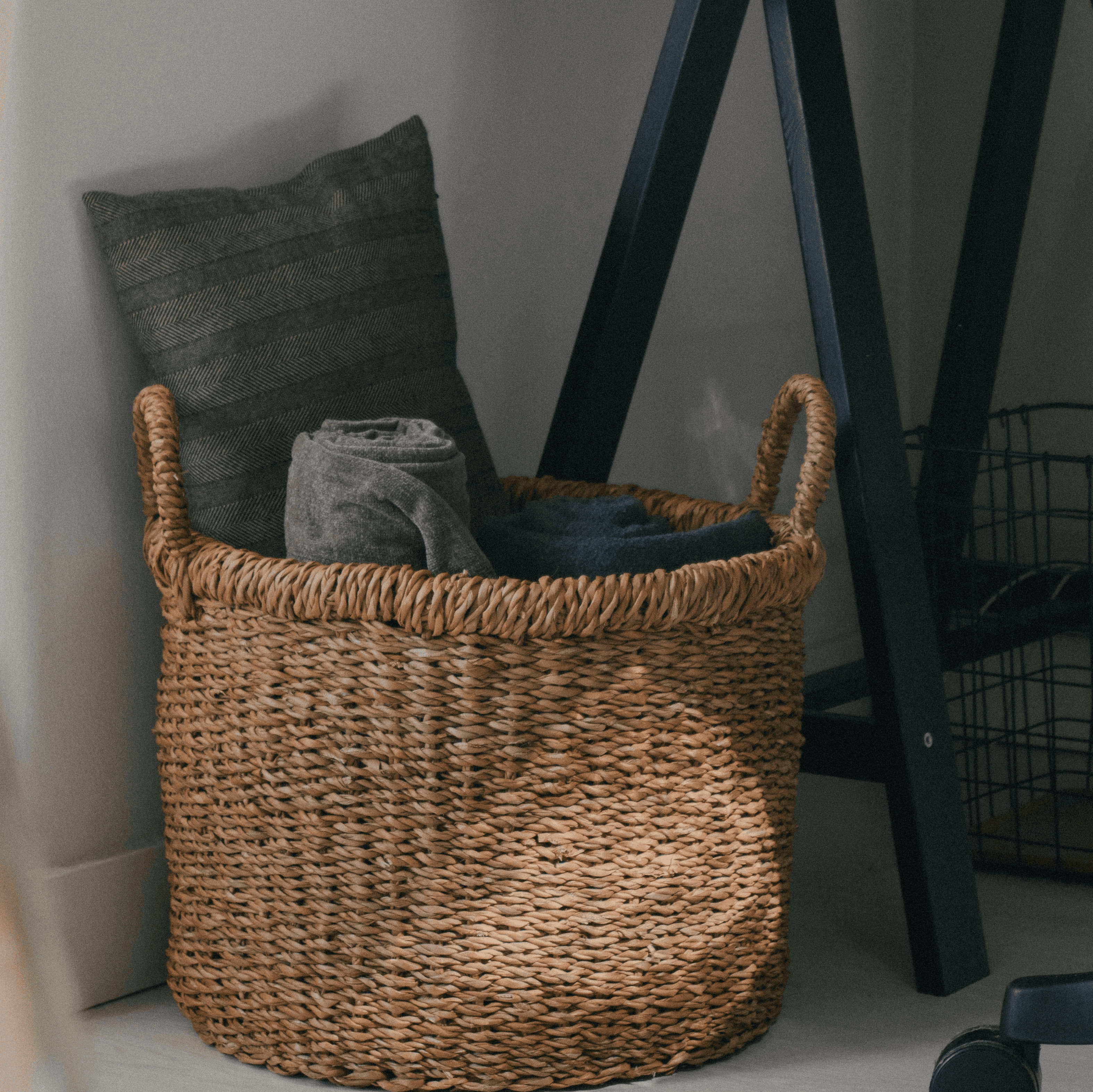 a basket sitting next to a computer on top of a desk