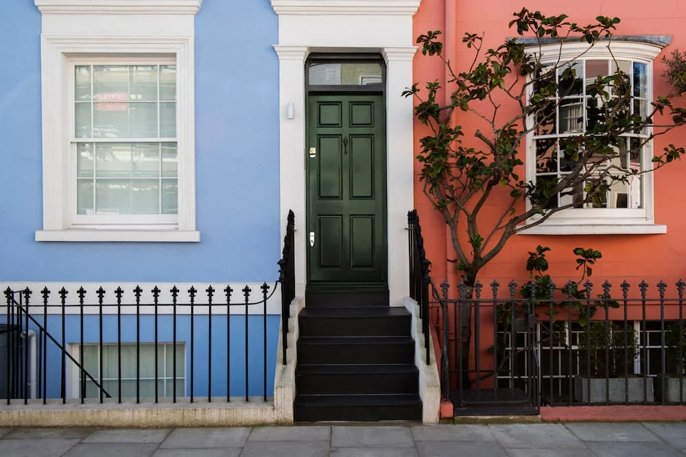 Green door of property highlighting the cost of conveyancing transaction failures on property market