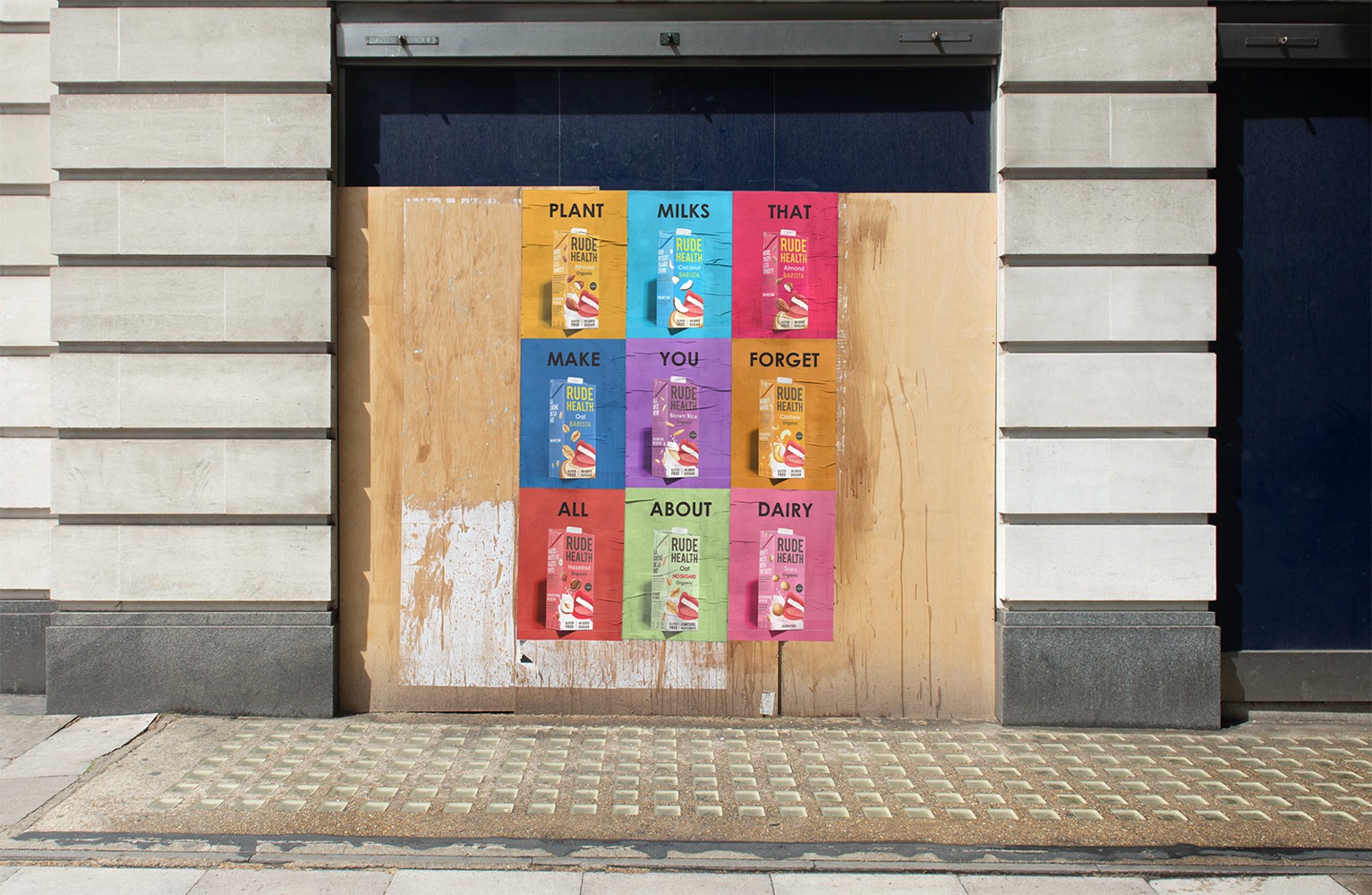 Streetside billboard with flyposters of the Batch.Works brand and illustrations