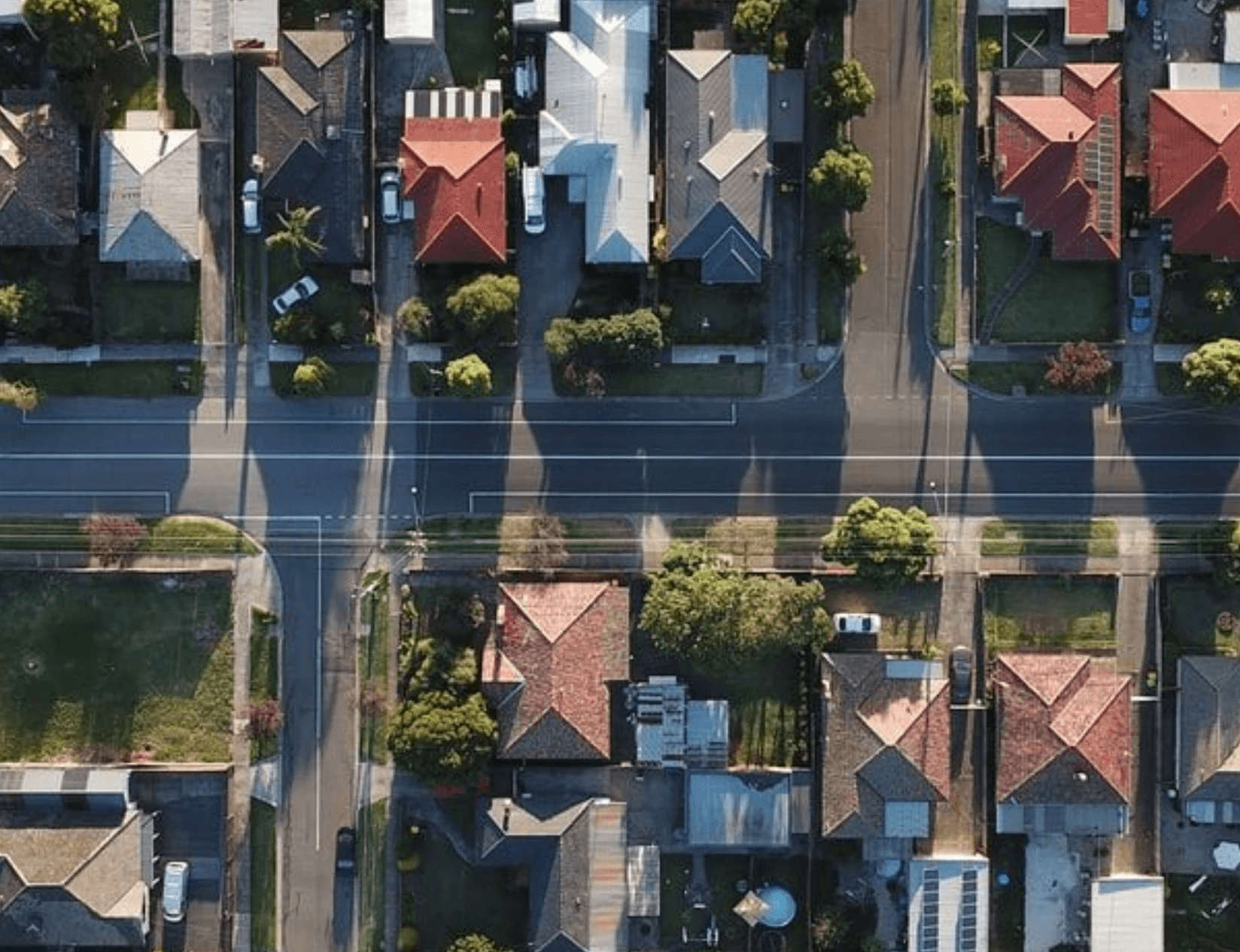 Aerial view of suburban neighborhood with houses and trees.
