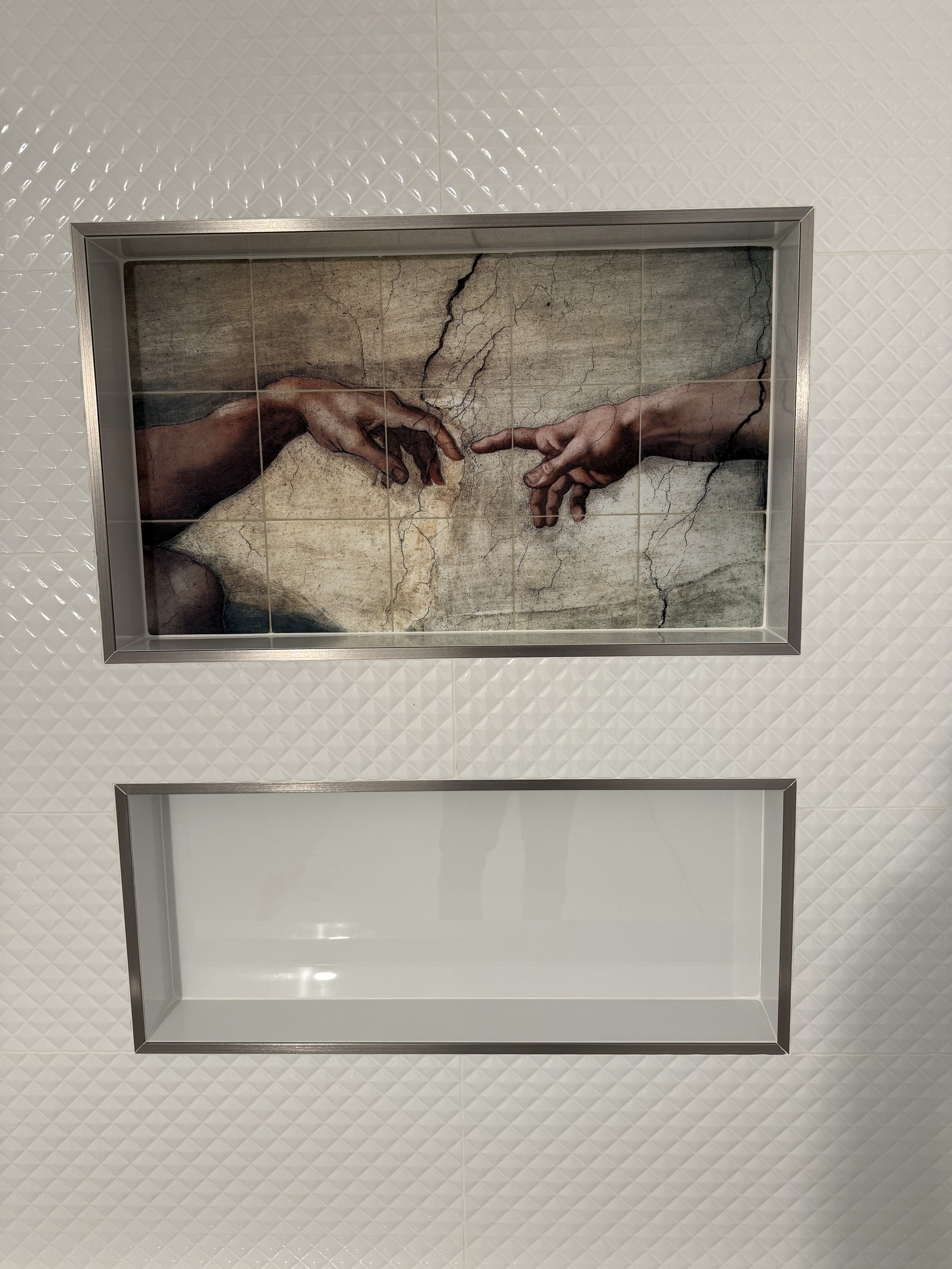 Luxurious bathroom vanity area with a dramatic wall featuring large format natural stone tiles in varying earthy tones and complex veining, serving as a striking backsplash above a double sink vanity.