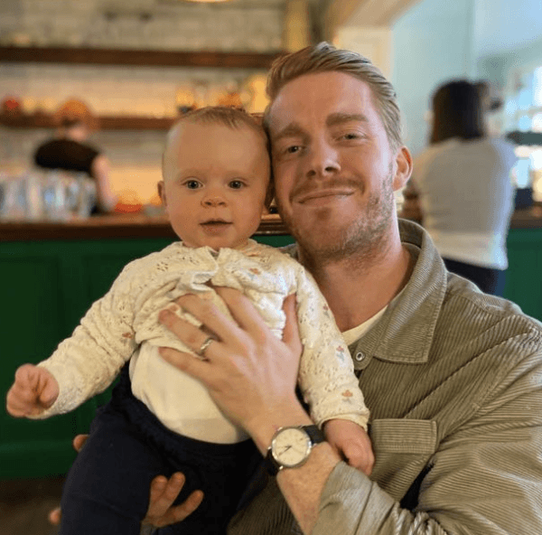 Testimonial photo of a man holding a baby