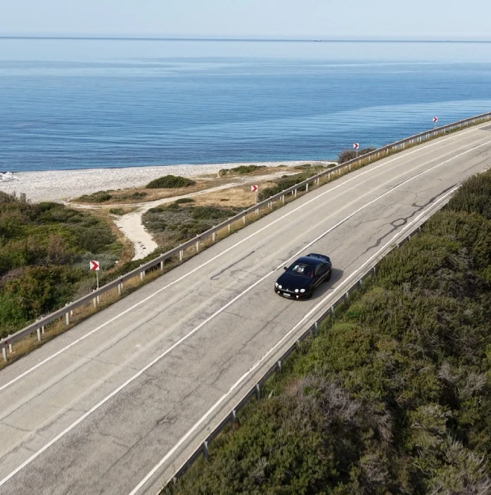 gray mercedes benz coupe on black asphalt road during daytime