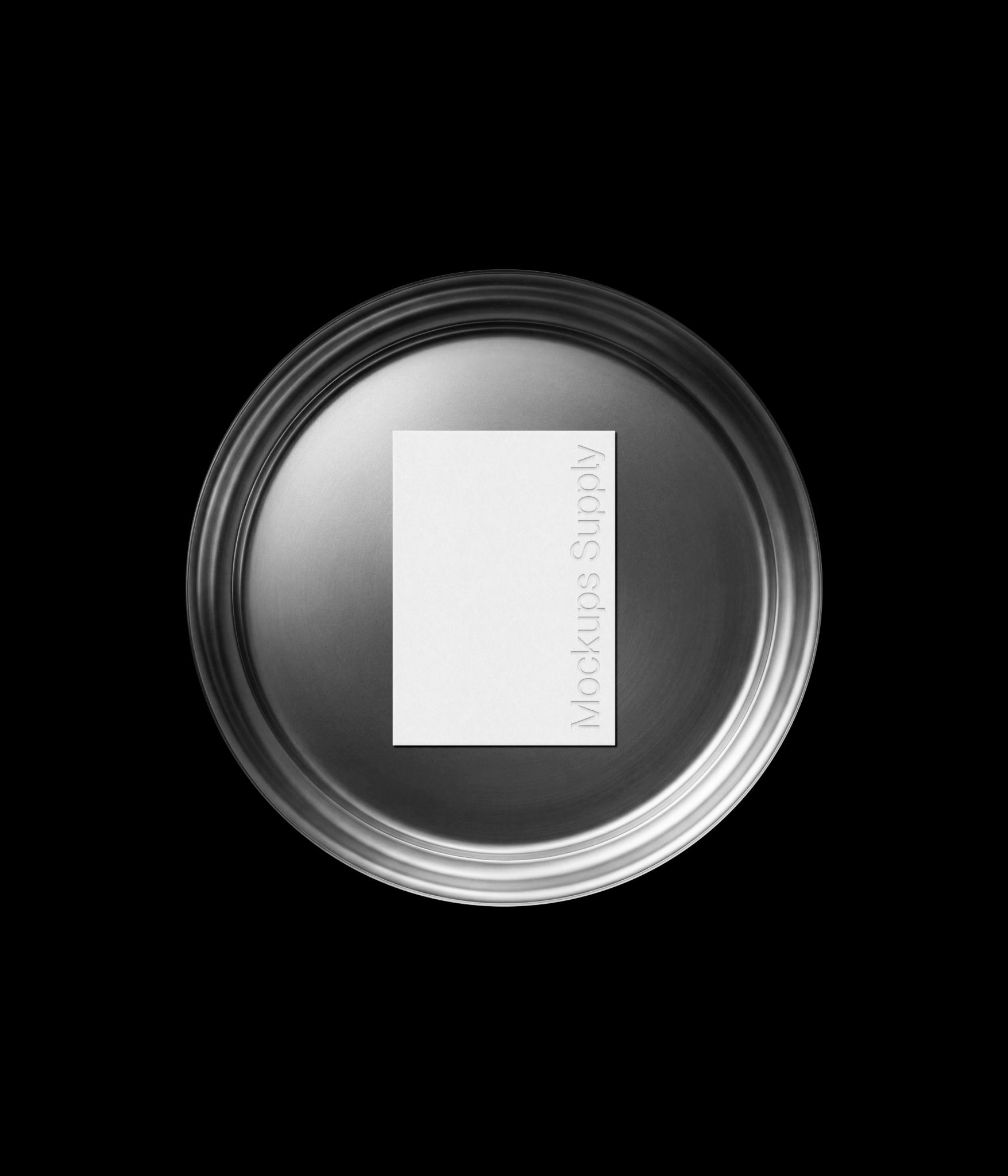Business card mockup on minimal round metal plate with debossed text effect for modern branding presentation
