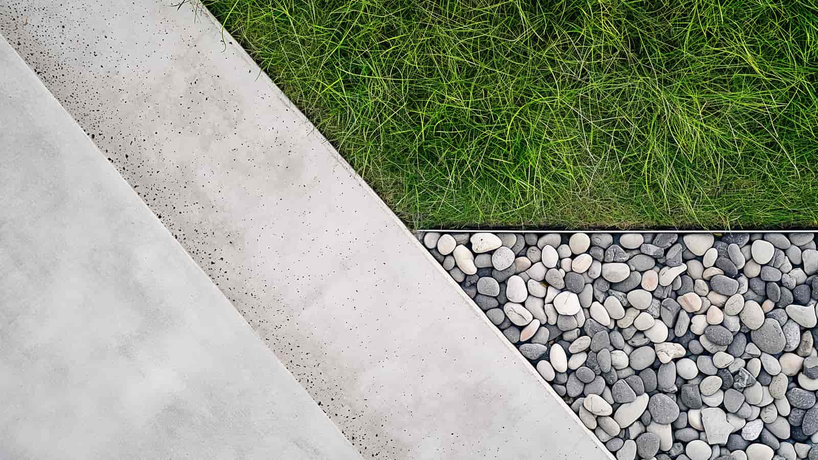 Grass meeting stone and gravel, layered landscaping materials detail