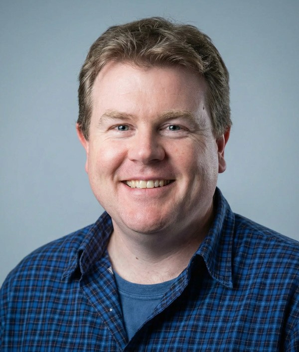 a person holding a cell phone in front of a laptop