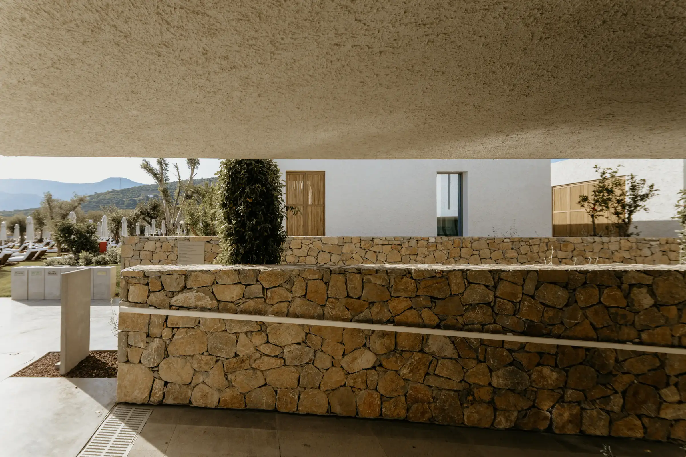 Stone wall with a white building behind
