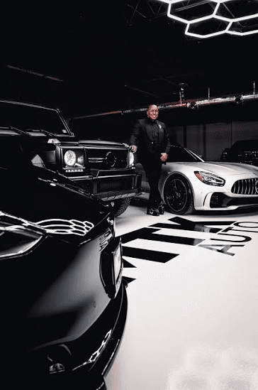 MTK Auto team member with vehicles in the showroom
