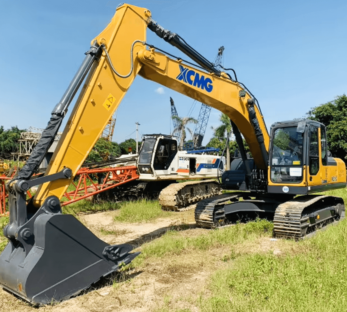 Two fathers carrying children on shoulders on a mountain path.