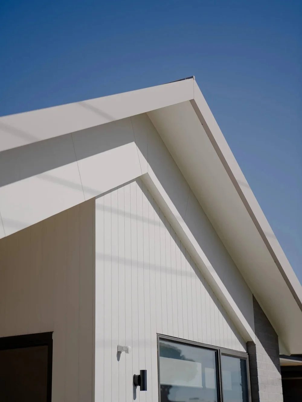 Modern house roof with blue sky background.