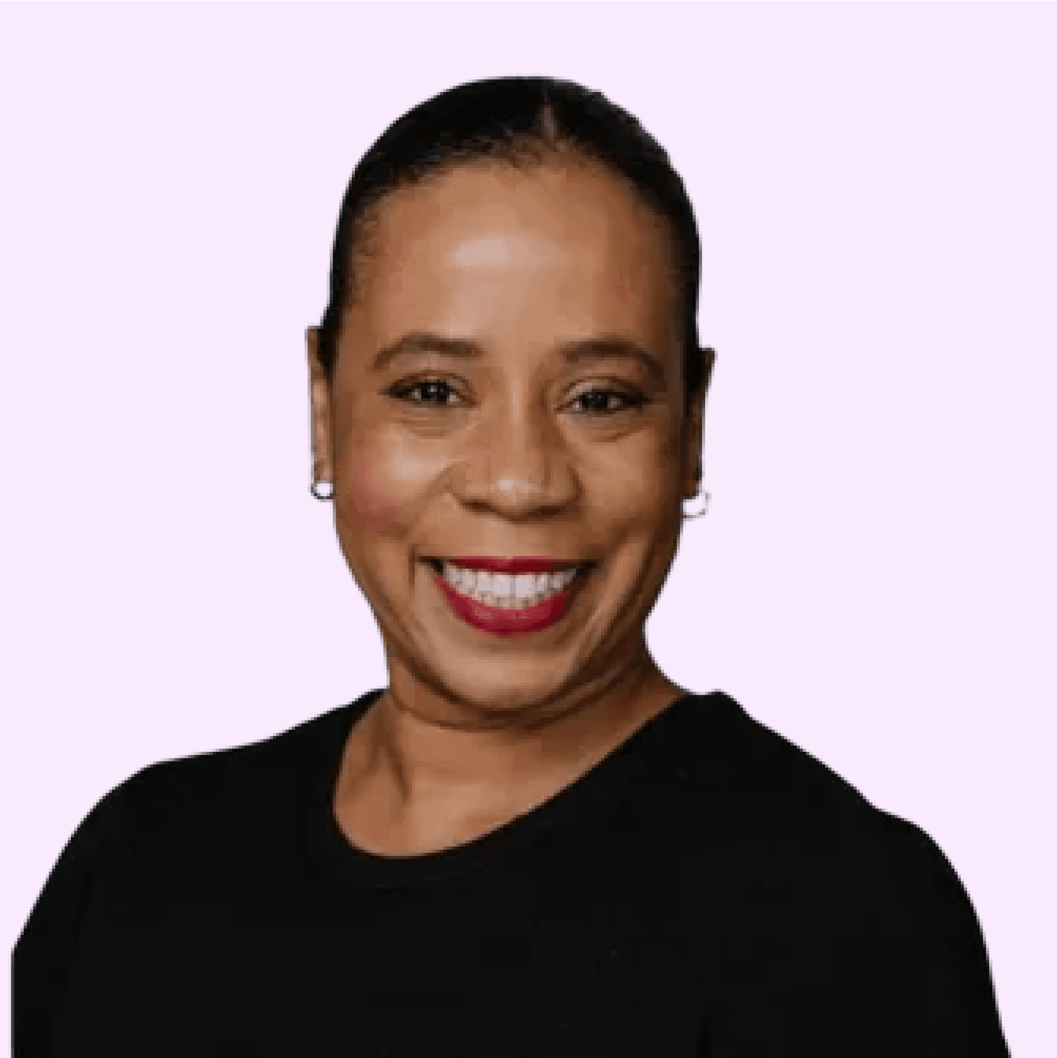 Smiling person in a black shirt against a soft purple background, portraying confidence and warmth.