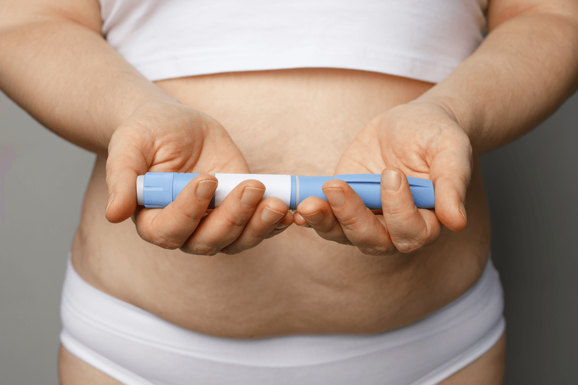 person holding injection - How Long Does Semaglutide Stay in Your System