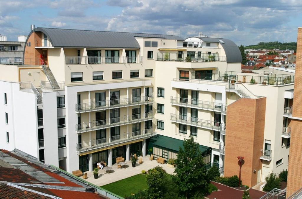 Modern residence facade with contemporary architecture	balconies	and street-level entrance