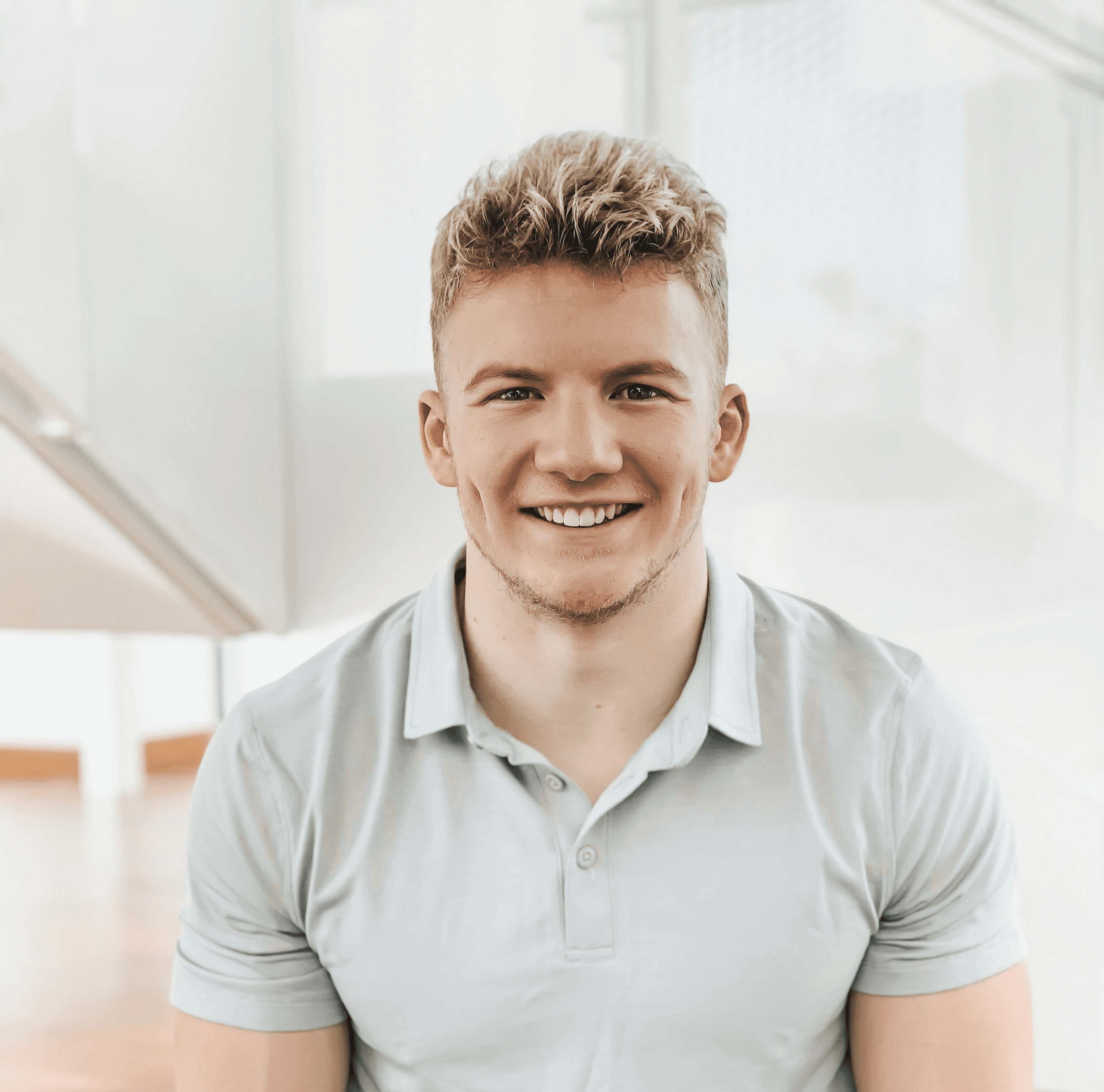 man in gray polo shirt smiling