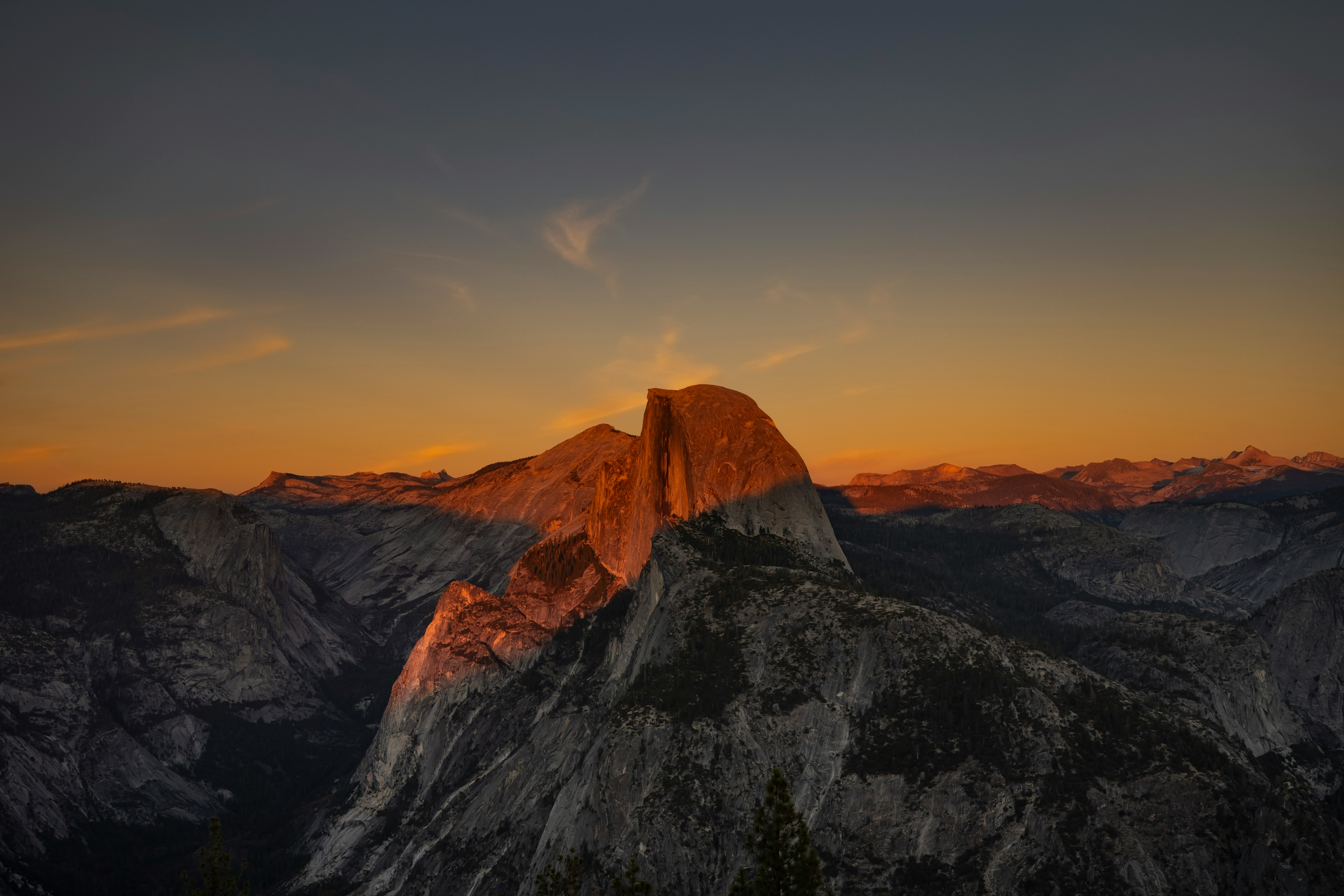 Half dome illuminated by golden sunset light.