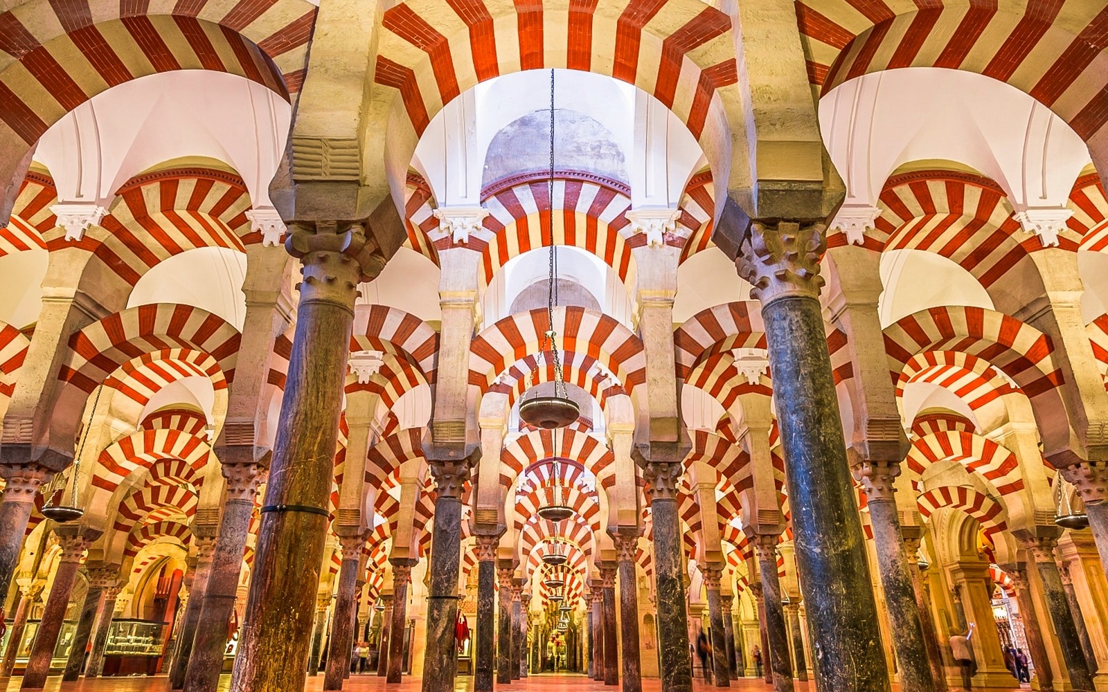 Interior of the Mosque-Cathedral of Córdoba with red and white arches.