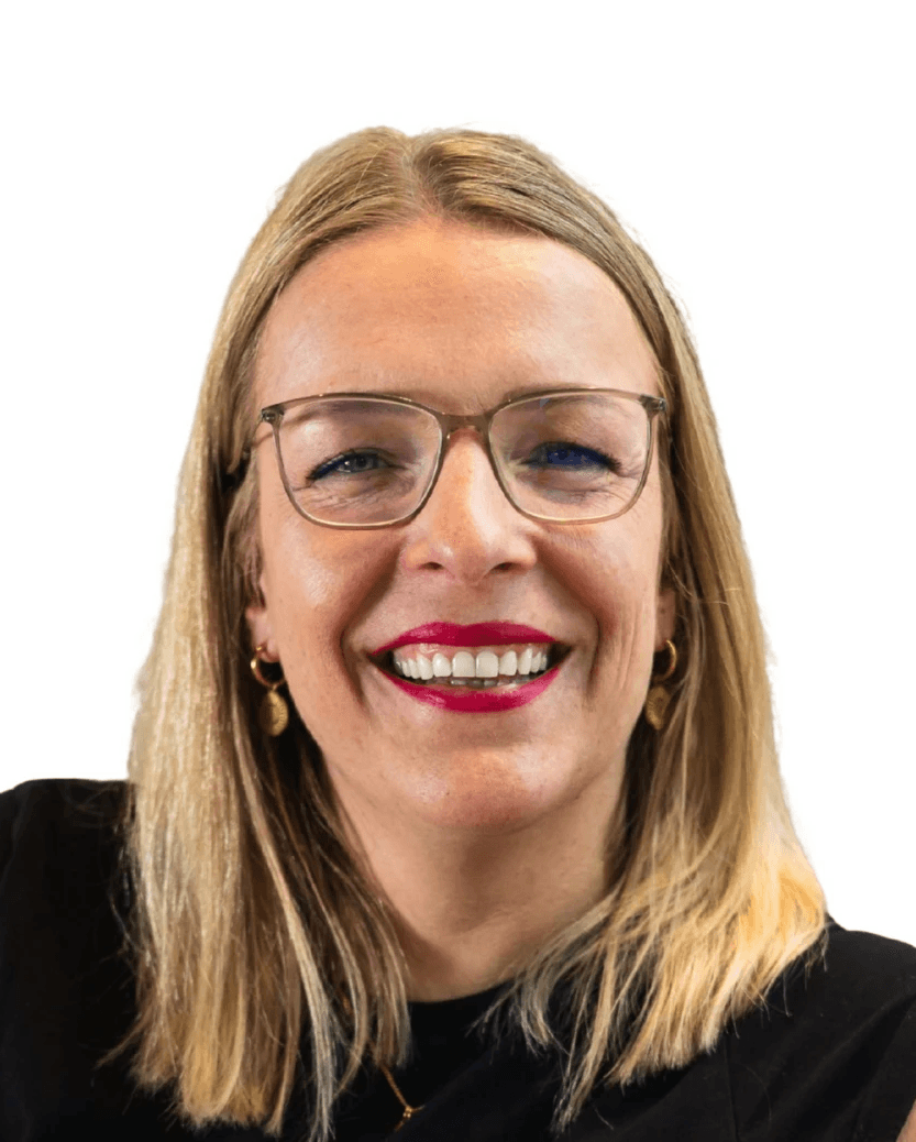 Close-up of a dark green leaf showing its textured surface and central vein against a muted background.