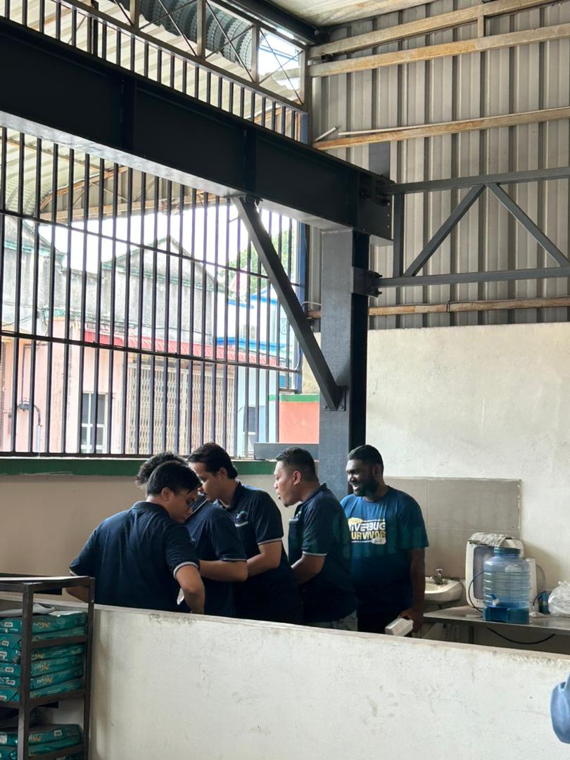 Autofill employees gathering under the covered area for the Deepavali celebration and tea break.